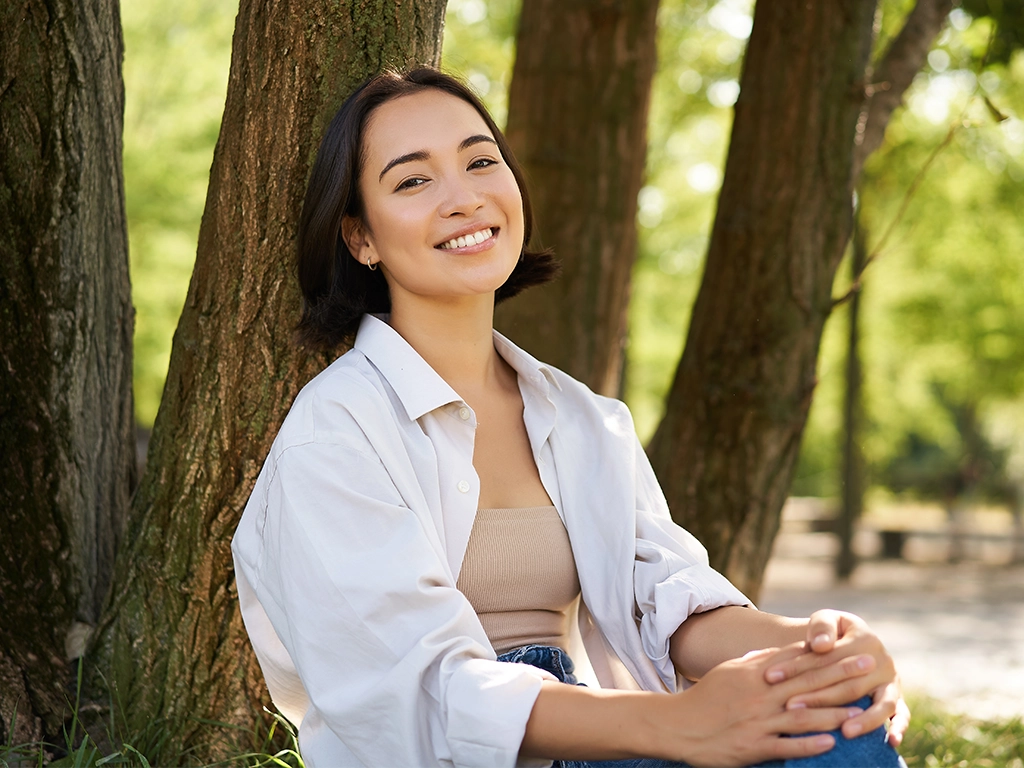 girl relaxing leaning on tree and resting in park smiling and enjoying the walk outdoors girl relaxing leaning on tree and resting in park smiling and enjoying the walk outdoors