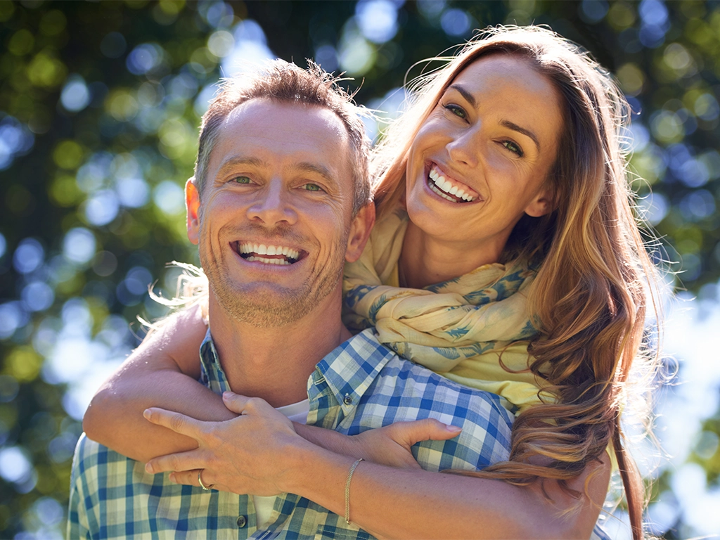 portrait of an affectionate couple outside in the summer sun portrait of an affectionate couple outside in the summer sun